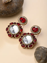 Statement earrings featuring a bold circular design with a vintage finish Red