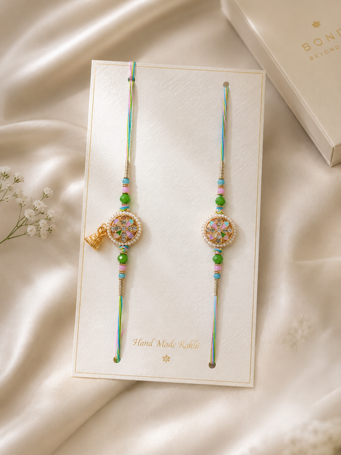 Designer Floral Pearl Rakhi Set with Pastel Enamel & Ghungroo Charm